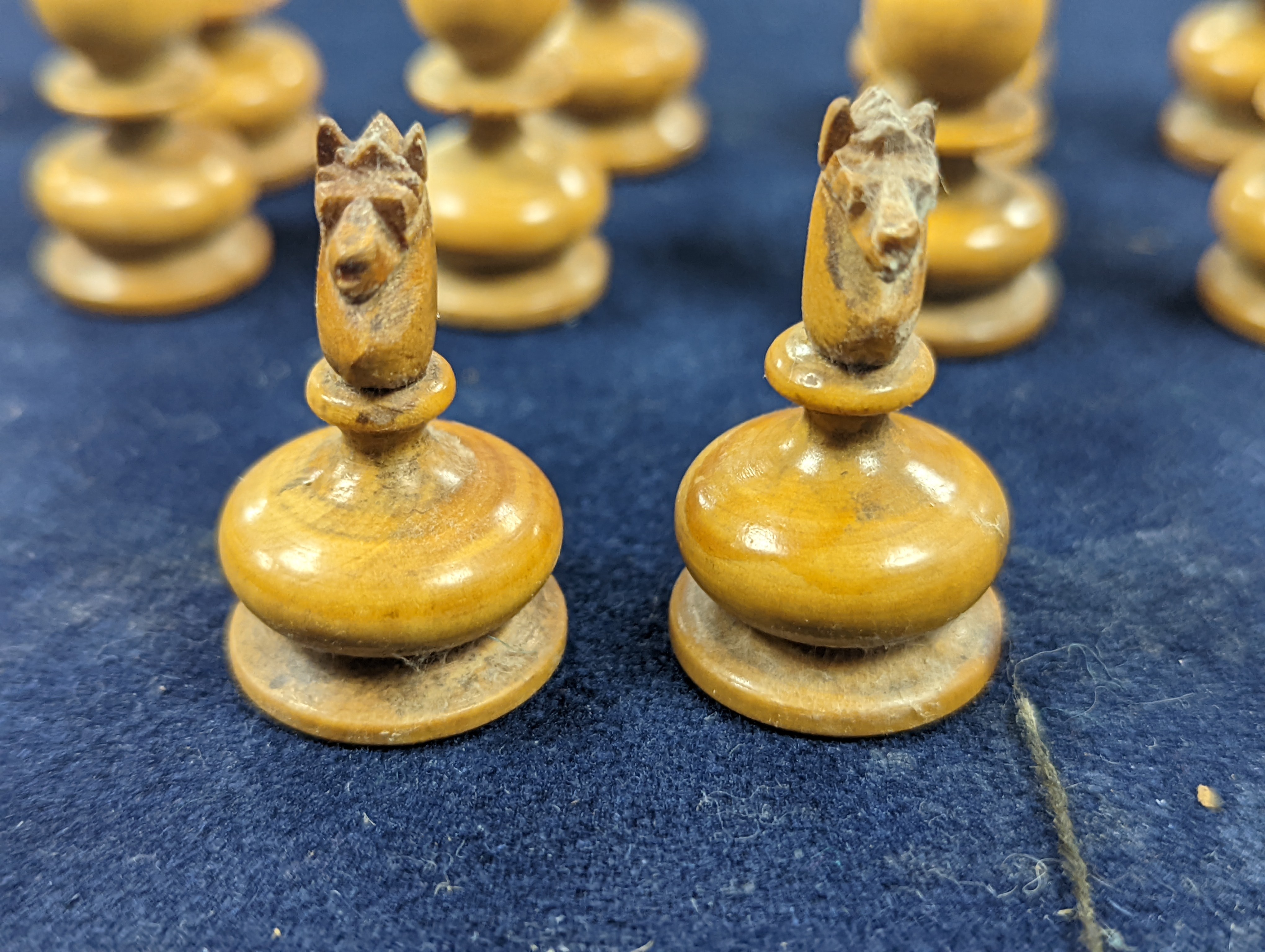 A Victorian brass inset mahogany games box, fitted with solitaire, cribbage, chessmen, draughts etc., 33cm, a turned and stained bone chess set, another games box containing chessmen and draughts